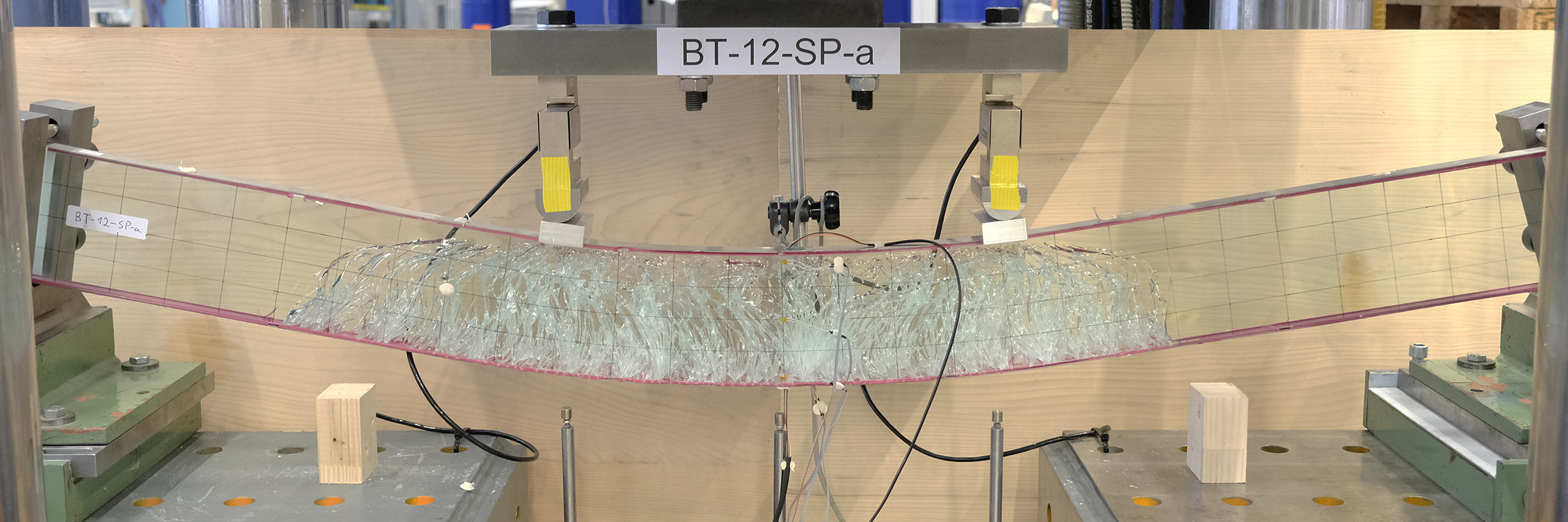 Post-tensioned laminated glass beam with adhesively bonded Fe-SMA strips after four-point bending test